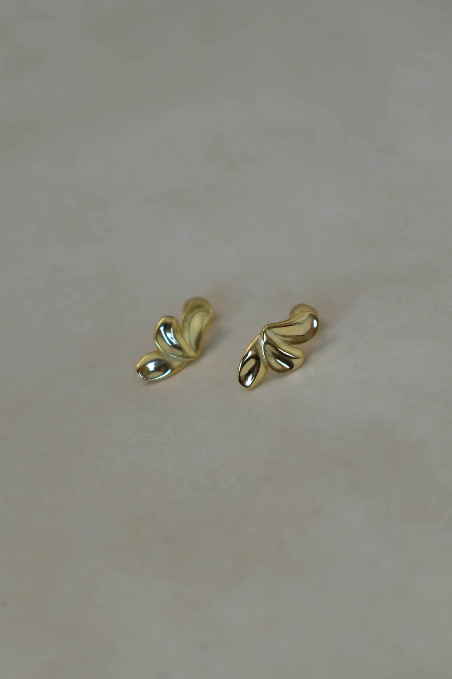 Gold leaf-shaped stud earrings