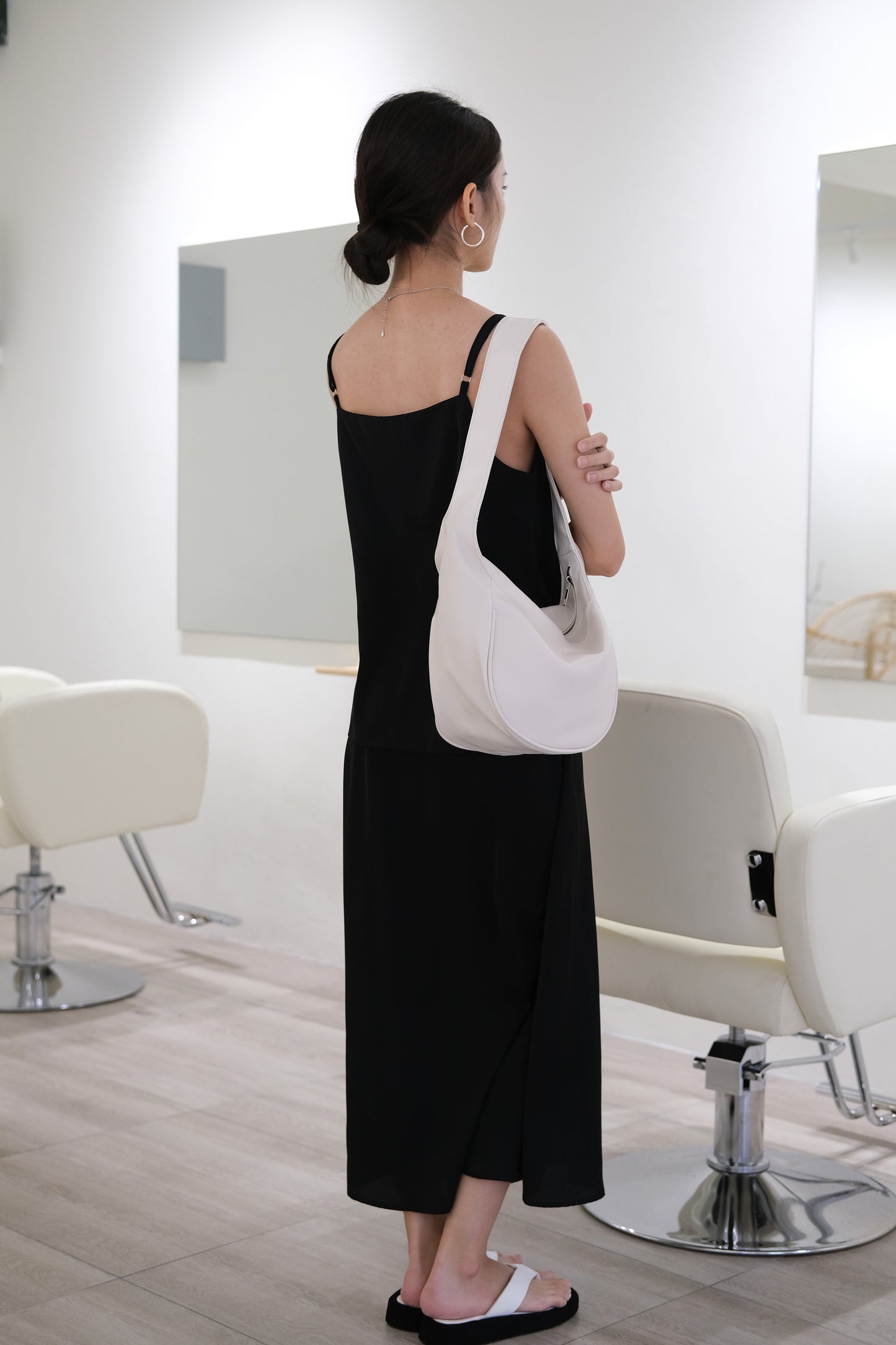 V-neck sleeveless vest + high-rise hip skirt in black color