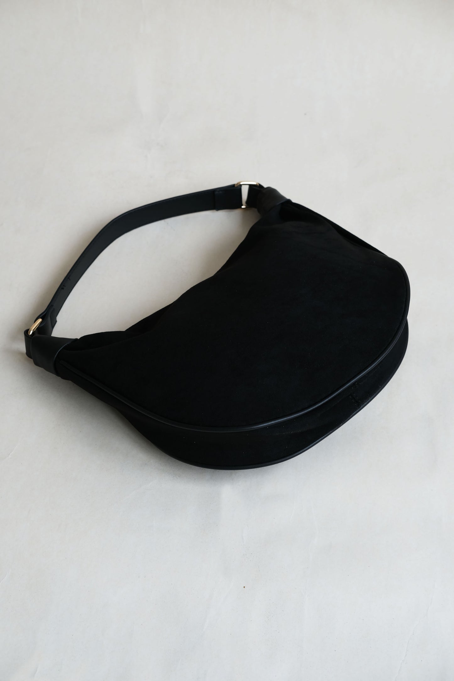 Underarm saddle dumpling bag in black color