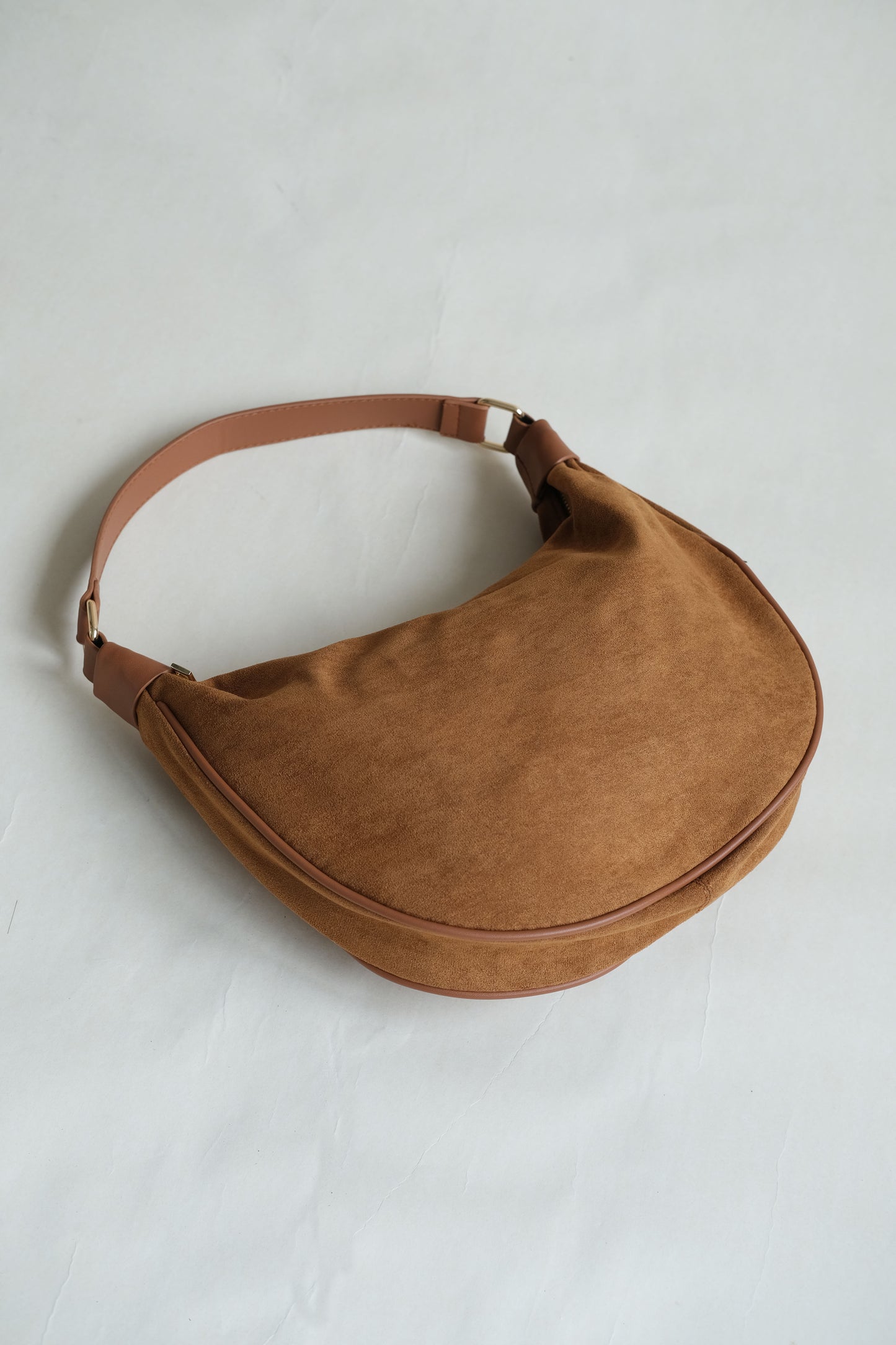 Underarm saddle dumpling bag in brown color