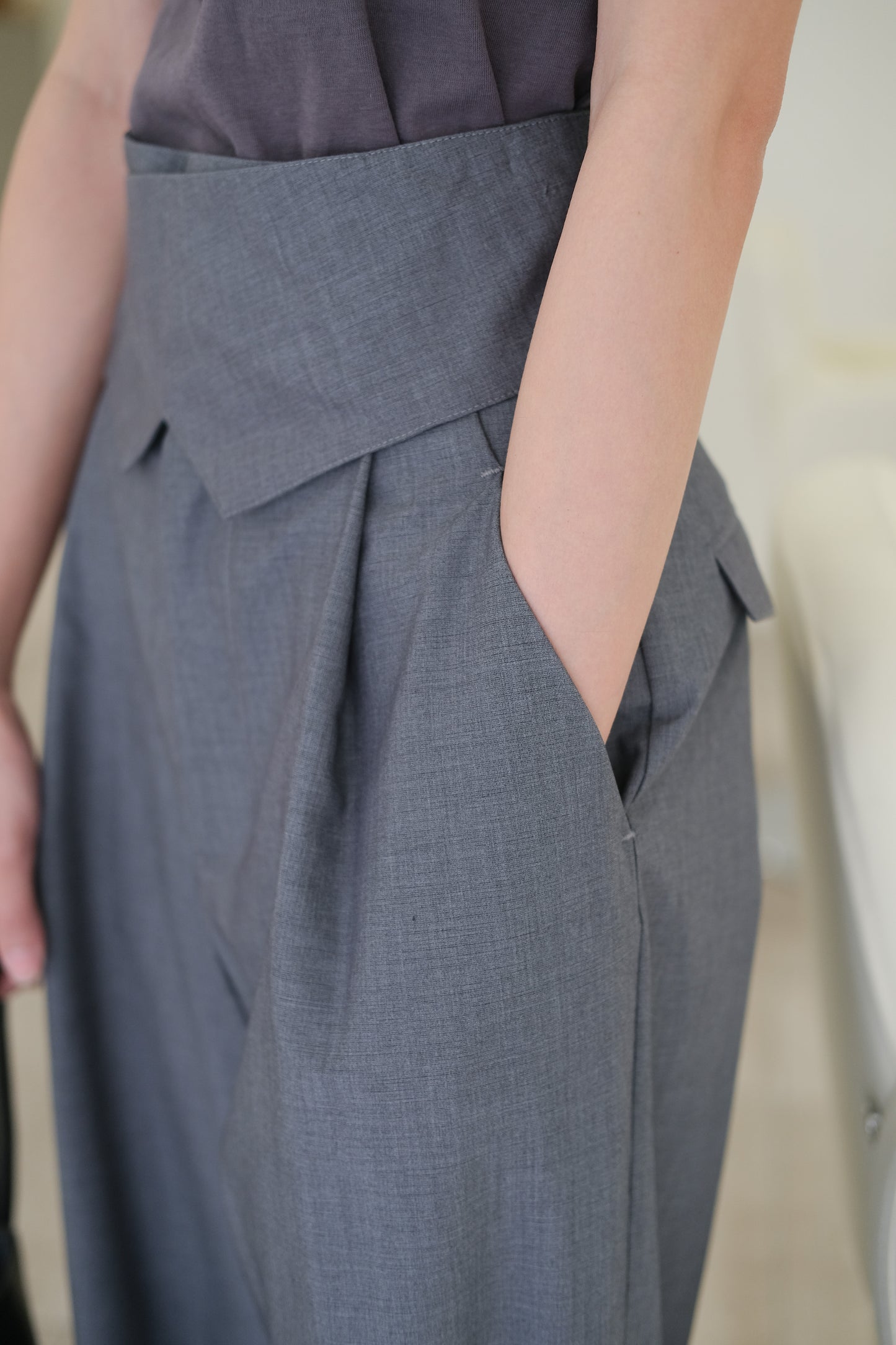 Adjustable button-up tabs and high-waisted wide-leg trousers in grey